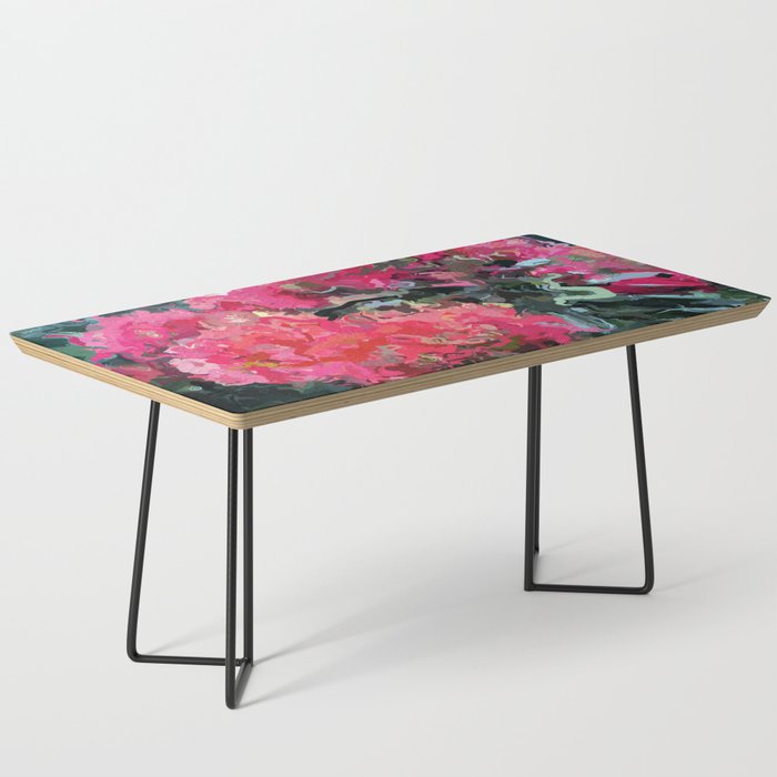 Red flower blossoms amid lush green foliage Coffee Table