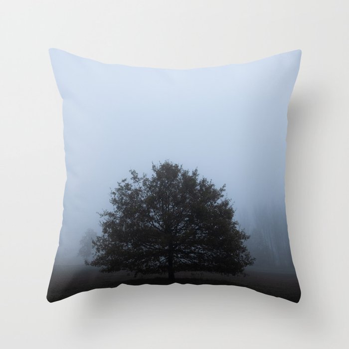 Tree standing in morning fog Throw Pillow