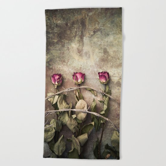 Three dried roses and barbed wire Beach Towel