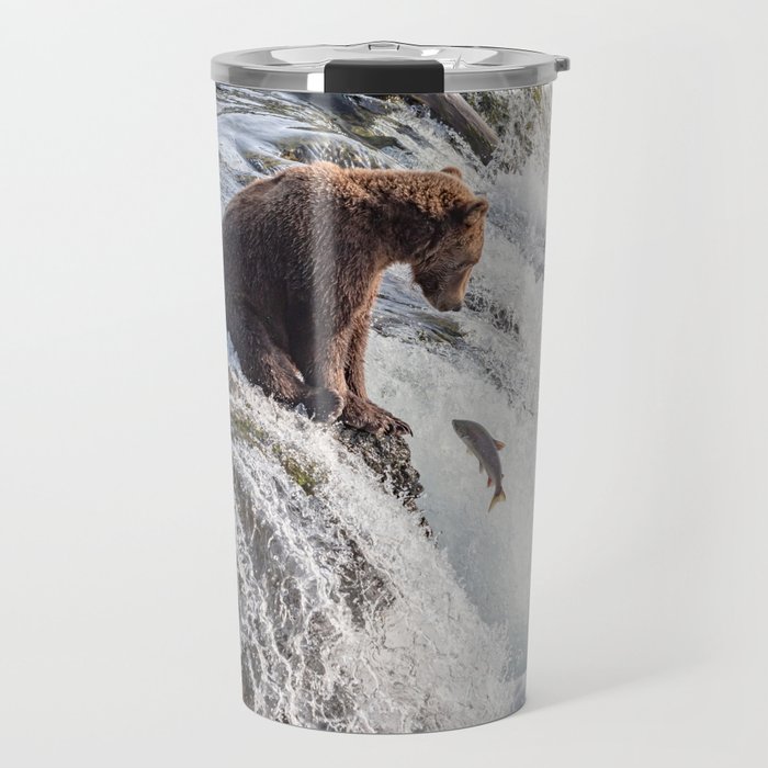 Young grizzly bear sits at waterfall Travel Mug