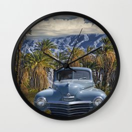 Vintage Blue Plymouth Automobile against Palm Trees and Cloudy Blue Sky near Palm Springs California Wall Clock