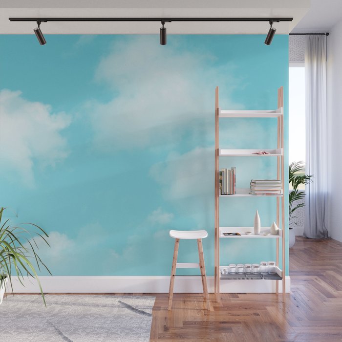 Cute puffy small white clouds on a sunny aqua blue sky Wall Mural