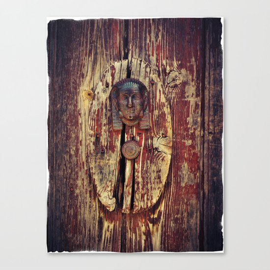 weathered wooden door with agypt door knocker Canvas Print