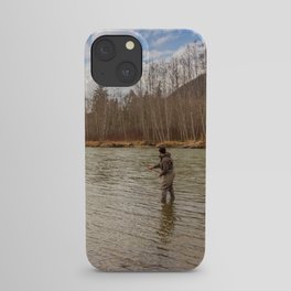 A fly fisherman hooked into a big fish on the Kalum River in the spring, British Columbia, Canada, with the rod bent and aspen woodland in the background iPhone Case
