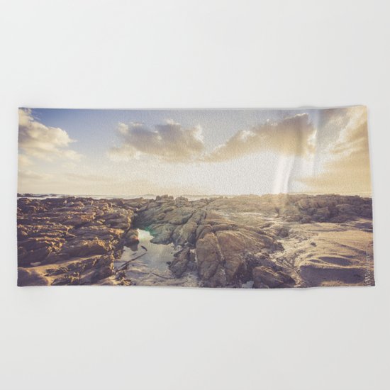 Golden hour, rocky beach landscape Beach Towel