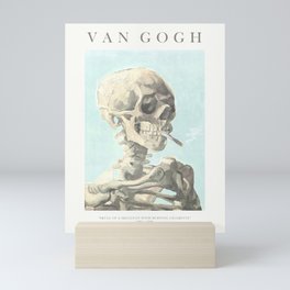 Vincent Van Gogh - Skull of a skeleton with burning cigarette (version with text & blue background) Mini Art Print