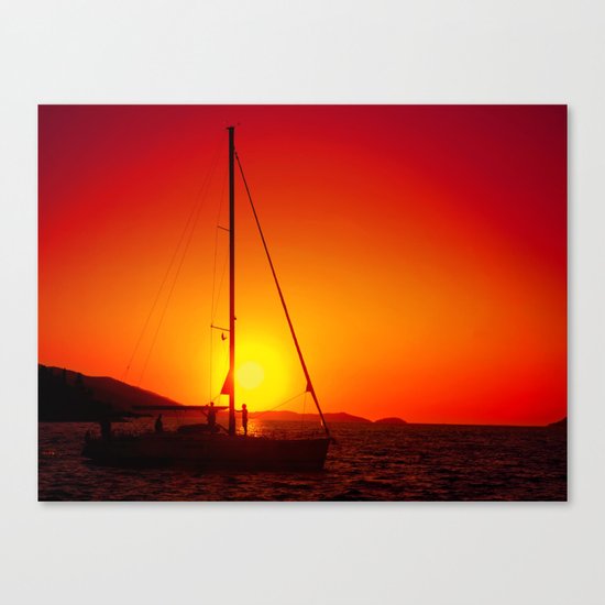 A sailboat at sunset Canvas Print