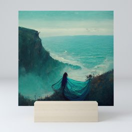 Woman on ocean cliff Mini Art Print
