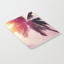 Tropical beach sunset background with palm tree silhouette. Vintage effect.  Notebook