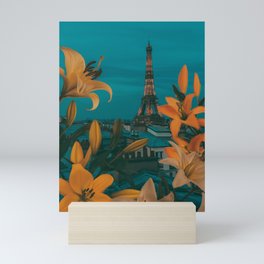 Lilies in bloom against the background of evening Paris. Mini Art Print