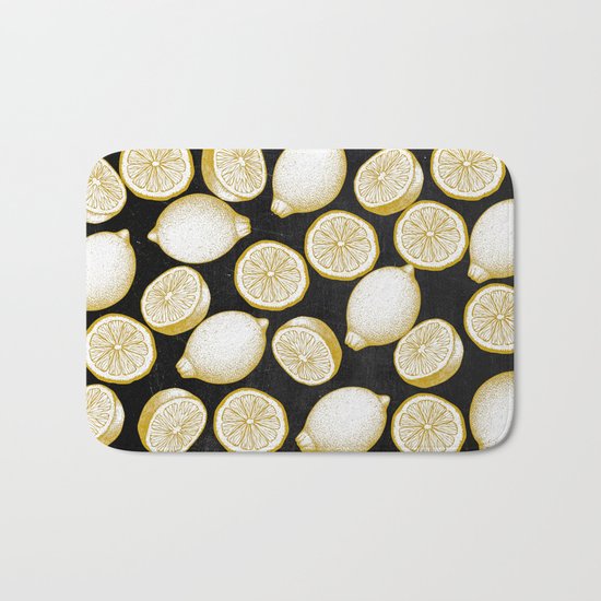 Lemons on black background Bath Mat