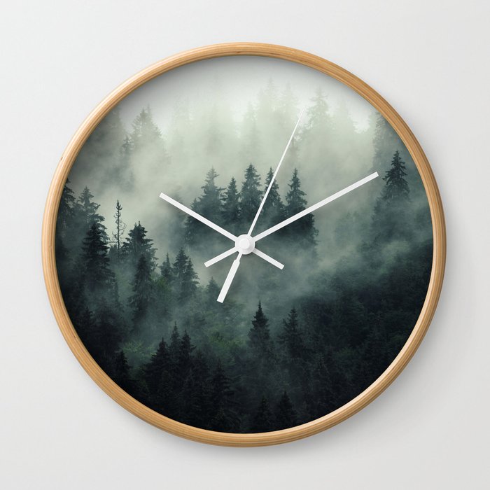 Misty pine forest on the mountain slope in a nature reserve Wall Clock
