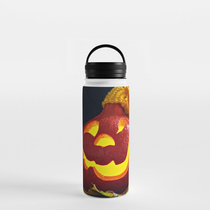 Glowing Pumpkin with Autumn Leaves on a Dark Background. Jack's Lantern. Halloween Decoration Water Bottle