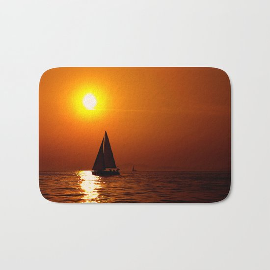 A sailboat at sunset Bath Mat