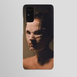 Girl moisturizing face mask. Portrait in a dark room. Beauty and skin care concept Android Case