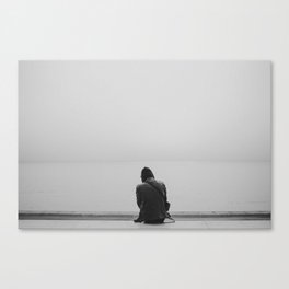 Man sitting on the shore in a foggy day. Lisbon Canvas Print