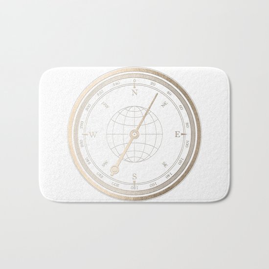 Gold Compass on White Bath Mat
