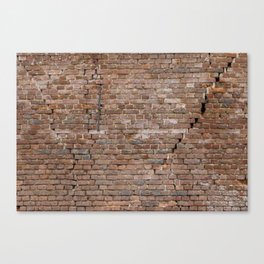 Large worn out brick wall background with large cracks Canvas Print