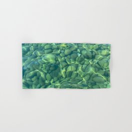 Beach pebbles under a crystal clear green water Hand & Bath Towel