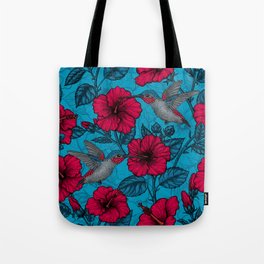 Red hibiscus and hummingbirds, tropical garden on light blue Tote Bag