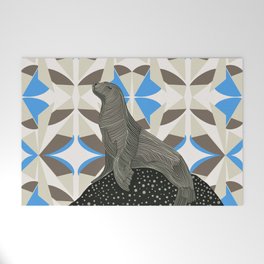 Seal sitting on rock with brown and blue patterned background Welcome Mat