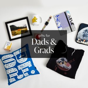 Assortment of printed pillow, notebook, framed art, coffee mug on the ground