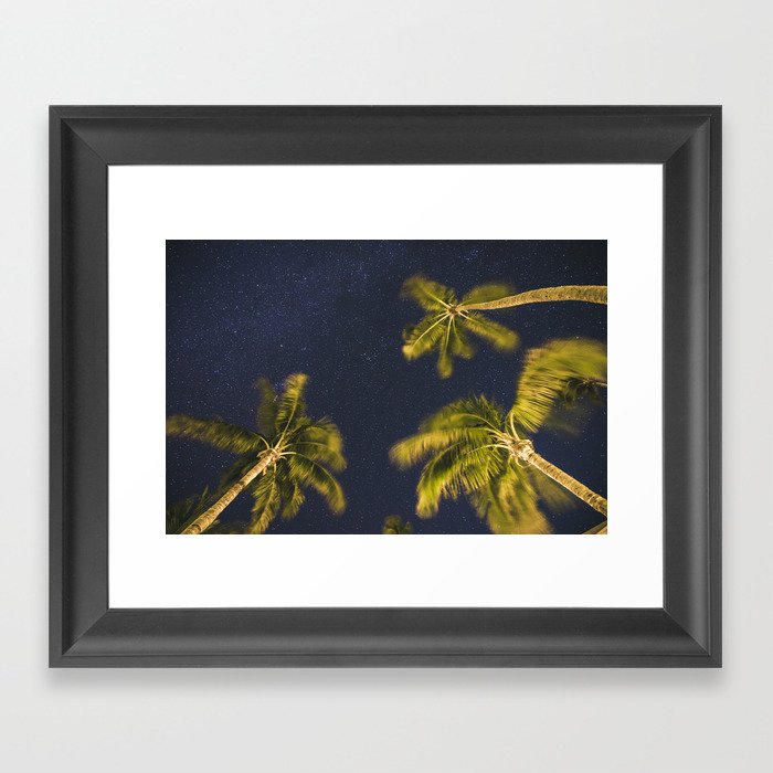 Palm trees at night against starry sky Framed Art Print
