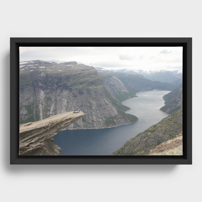 Laying on the edge of the world Framed Canvas