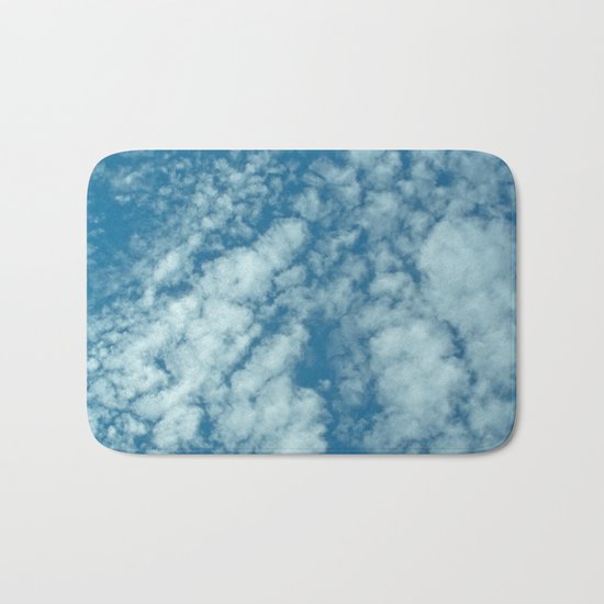 Fluffy clouds in a blue sky Bath Mat