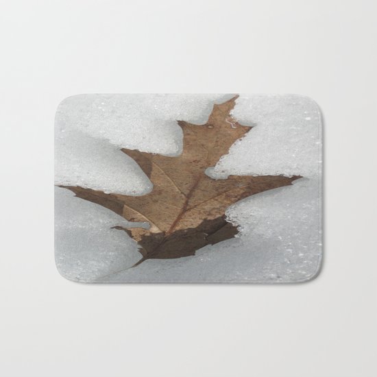 leaf in snow Bath Mat