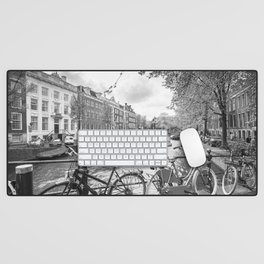 Bicycles parked on bridge over Amsterdam canal Desk Mat