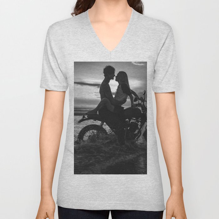 The motorcyclists; lovers at sunset on vintage motorcycle coastal beach romantic portrait black and white photograph - photography - photographs by Yuliya Kirayonak V Neck T Shirt