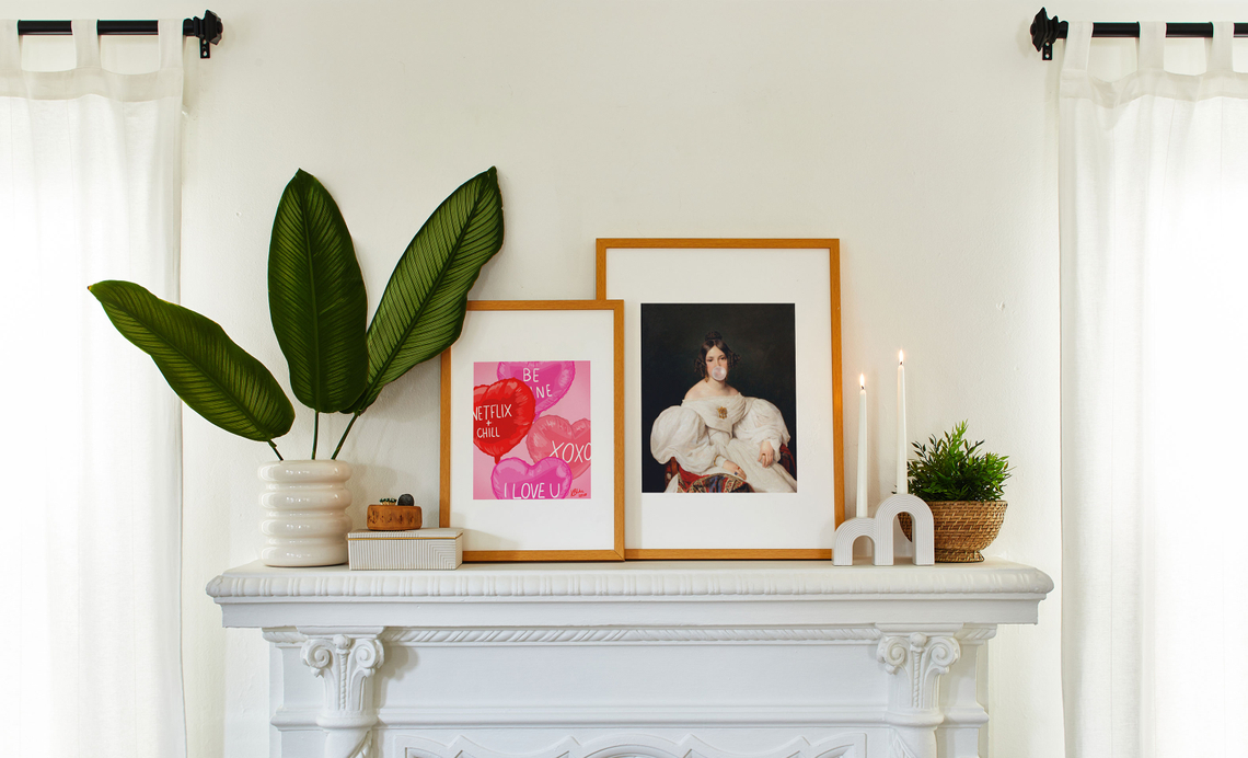 valentine's day themed framed prints on a mantel