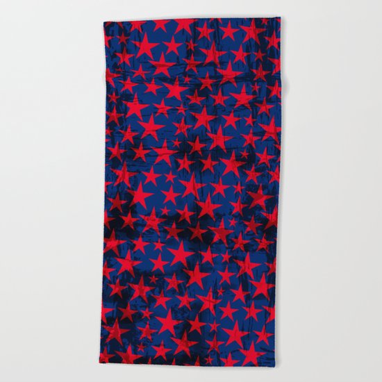 Red stars on grunge textured blue background Beach Towel