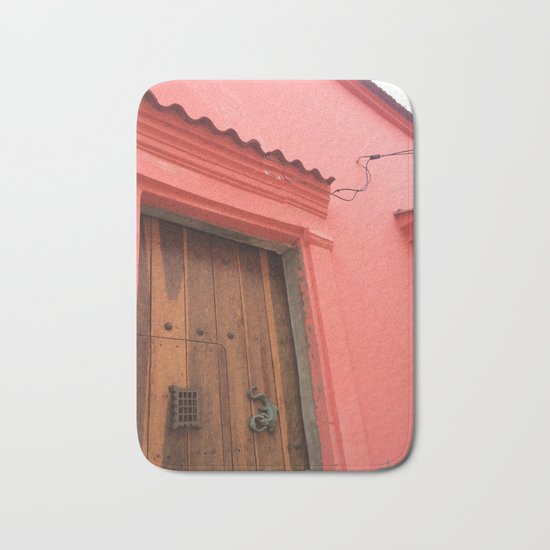 Cartagena is Peachy, Colombia, South America. Coral Pink Building with Ornate Lizard design Bath Mat