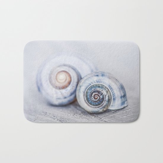 Blue Shells on white washed wood in soft pastel blues Bath Mat