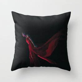 Goddess in the red dress stands in the dark Throw Pillow