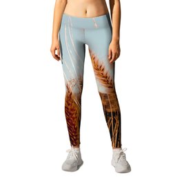 blooming grass flowers with blue sky and mountain background Leggings