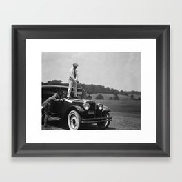 Pro golfer hitting golf ball off vintage car hood ornament on a dare par one 18th hole funny black and white golf sport photograph - photography - photographs Framed Art Print
