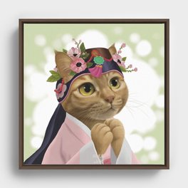 A cat wearing an 'ayam' Framed Canvas