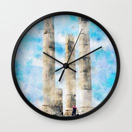 People Walking on Gray Concrete Pillar Under Blue Sky Wall Clock