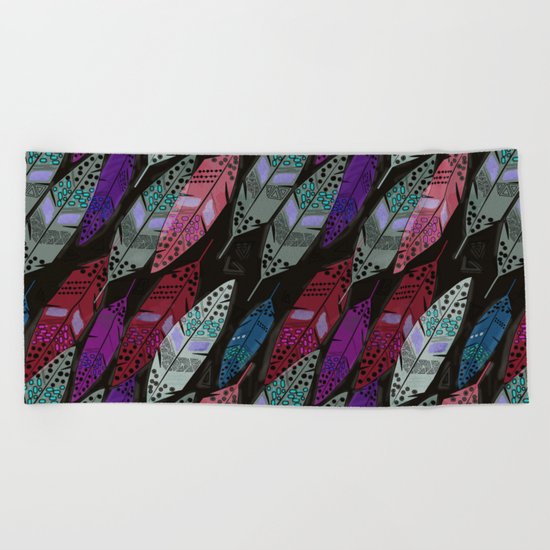 Multi colored feathers on black background . Beach Towel