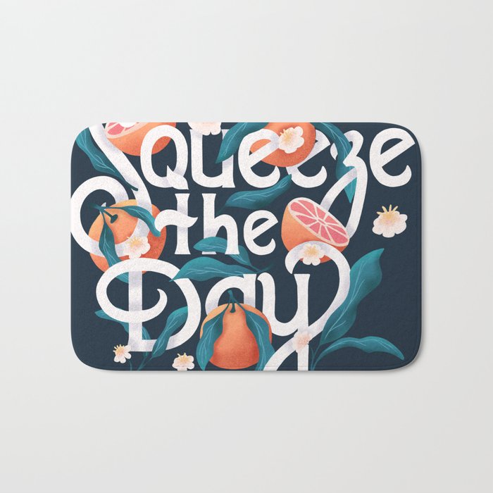 Squeeze the day lettering illustration with oranges on dark blue background. Hand lettering; fruit and floral design in bright colors.  Bath Mat