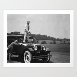 Pro golfer hitting golf ball off vintage car hood ornament on a dare par one 18th hole funny black and white golf sport photograph - photography - photographs Art Print