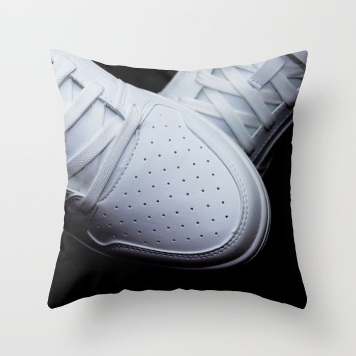 White sneakers on a black background Throw Pillow