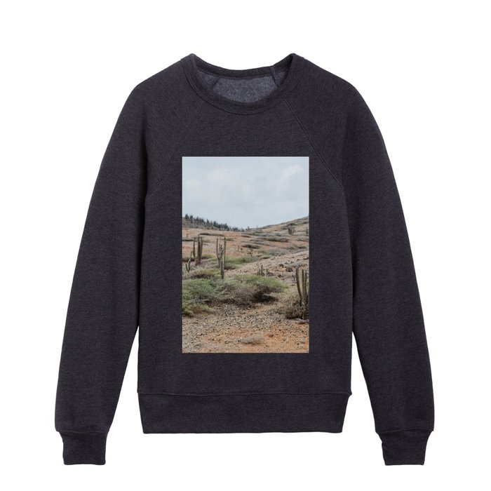 The dry rocky desert of Aruba with cacti and warm earthy colors Kids Crewneck