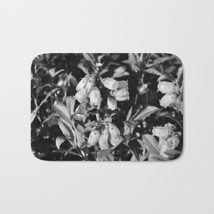 Tiny Blossoms On A Dirt Road in Black and White Bath Mat