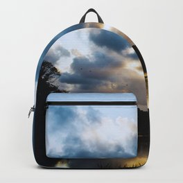 Sunset Fluffy Blue Clouds and Reflection on the Water Backpack
