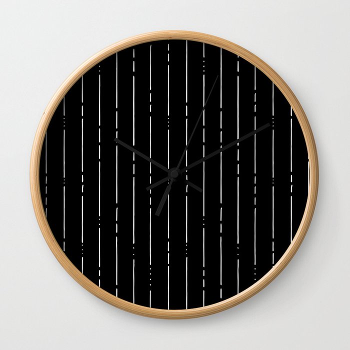 broken lines vertical white on black wall clock by stripes society6
