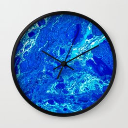 AN ABSTRACT PATTERN IN THE BLUE WATER SURFACE Wall Clock